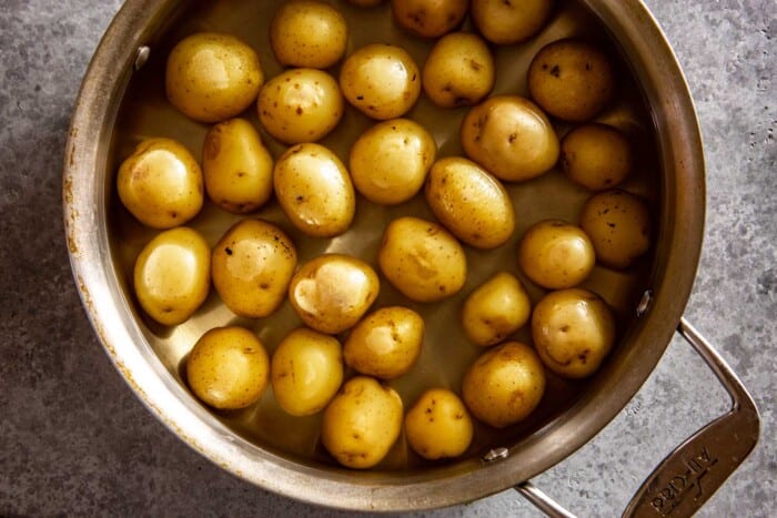 potatoes in a shallow saute pan filled with water