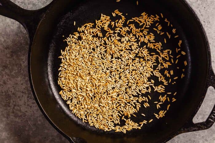 toasted rice in a cast-iron skillet
