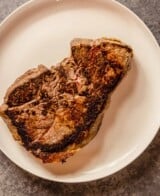 cooked beef sirloin steak on a white plate