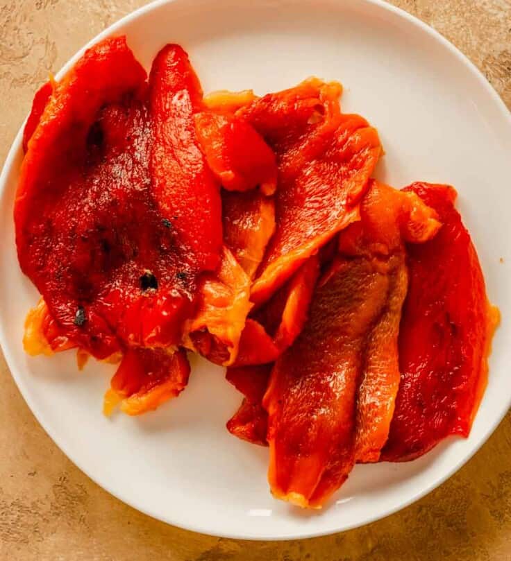 roasted red bell peppers on a white plate