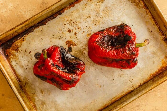 roasted red bell peppers on a baking sheet.