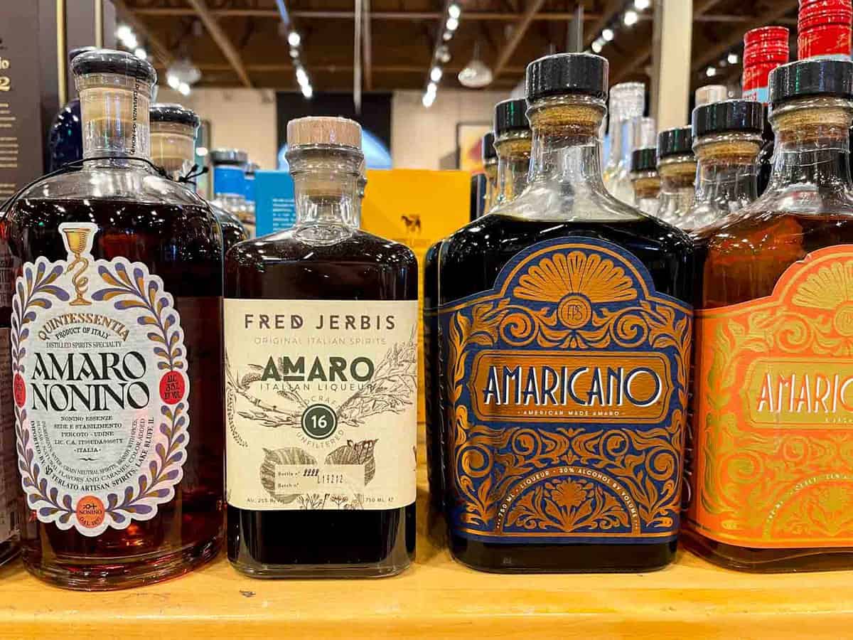 four bottles of amaro on a shelf