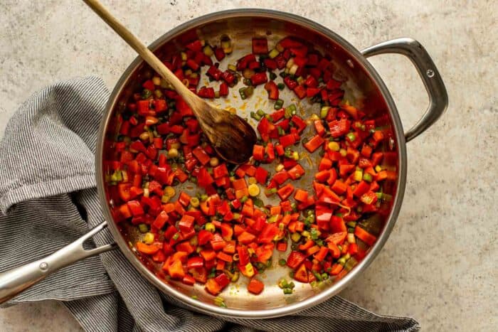 diced bell peppers sauteed in a saute pan