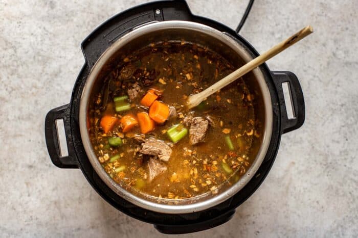 vegetables and broth cooking in an instant pot