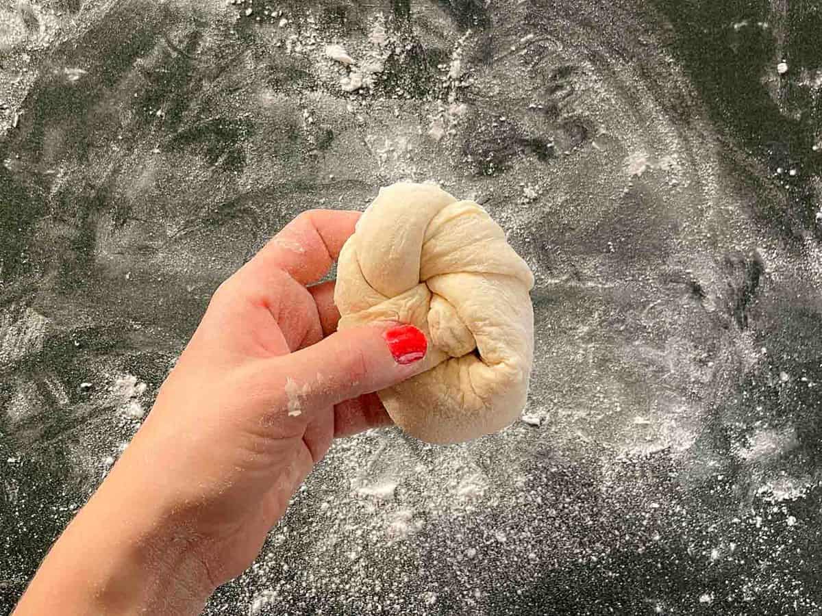 knotted roll of dough in a hand