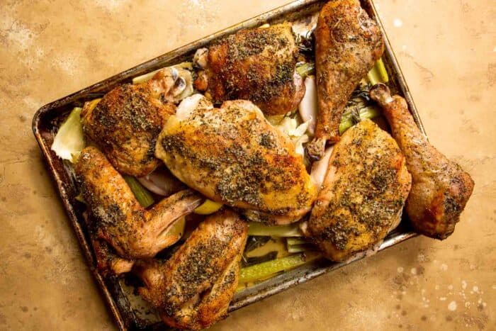 roasted spice-coated turkey pieces on a baking sheet with vegetables