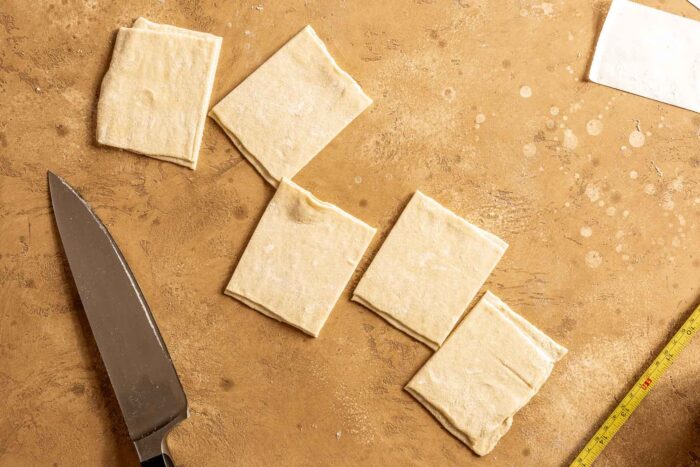5 squares of pastry dough set on a counter