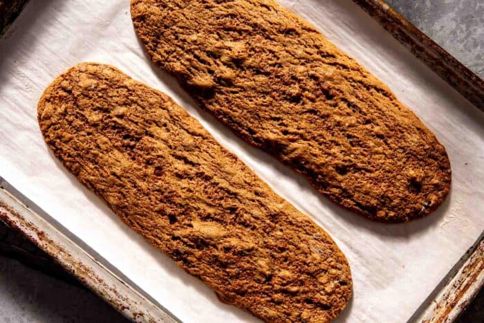 large baked cookie logs on a parchment-lined baking sheet