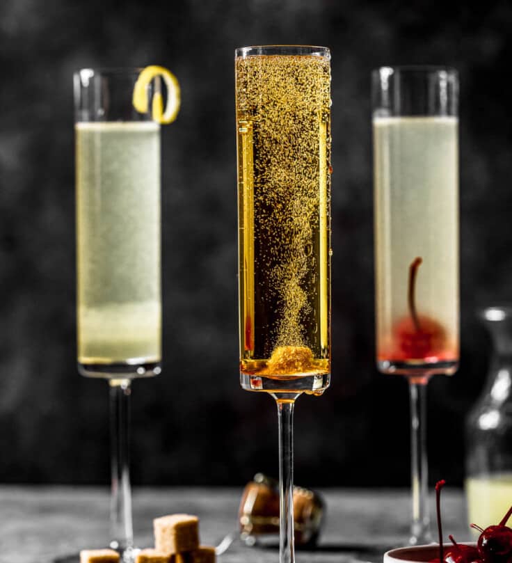 golden-hued champagne cocktail in a tall champagne flute