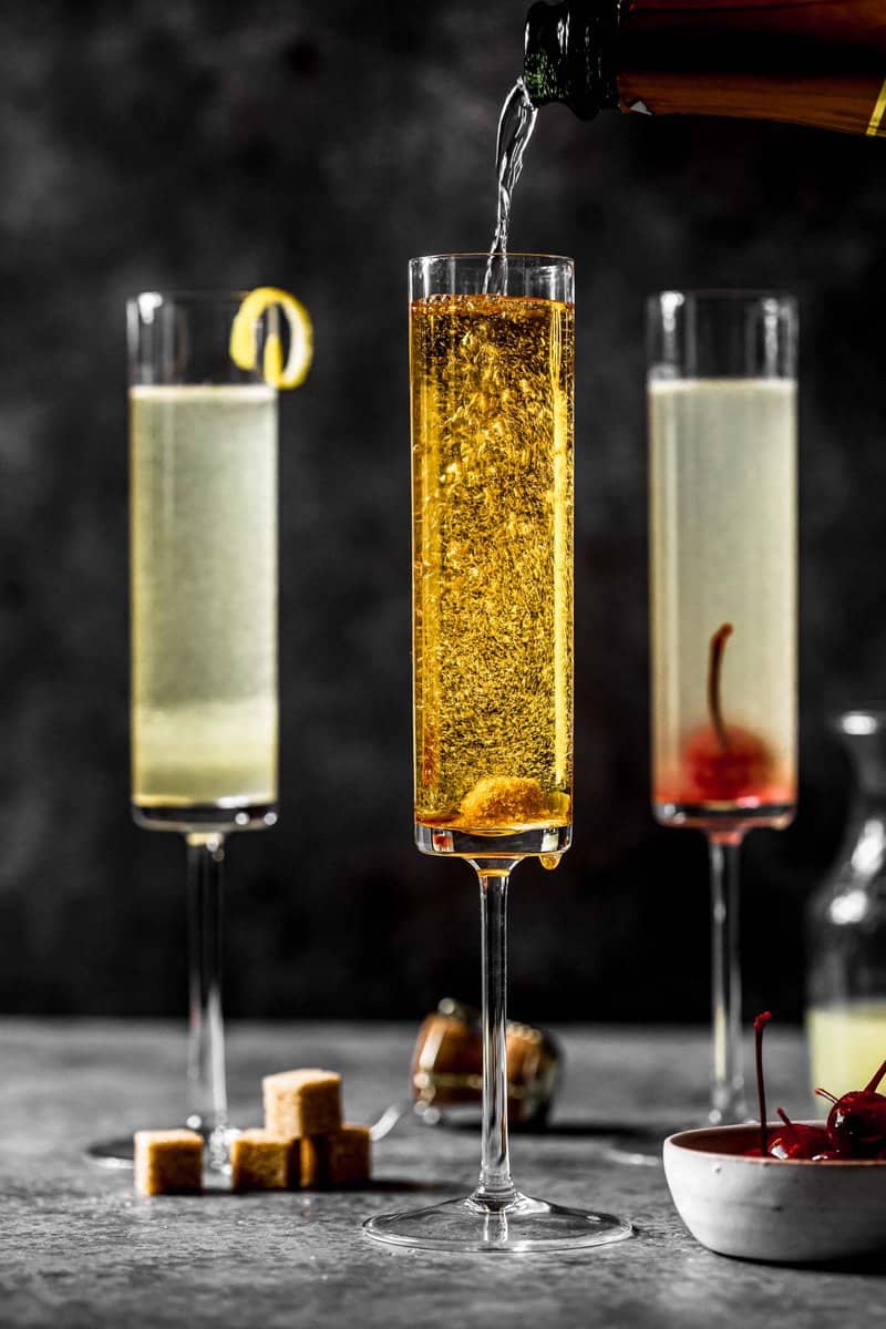 golden-hued champagne cocktail in a tall champagne flute