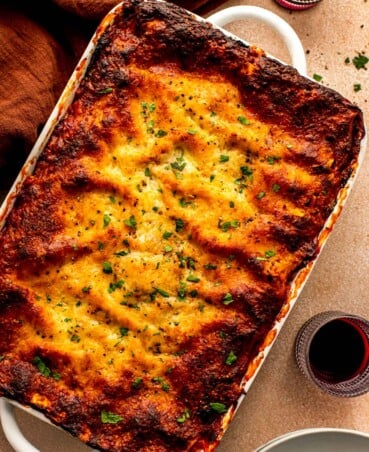 deeply browned lasagna in a large white baking dish