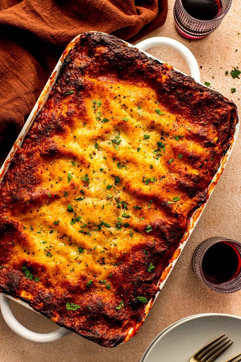 deeply browned lasagna in a large white baking dish