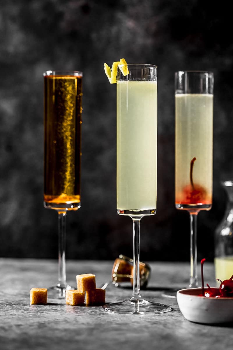 sparkling wine and lemon cocktail in a tall champagne flute with a lemon twist as garnish