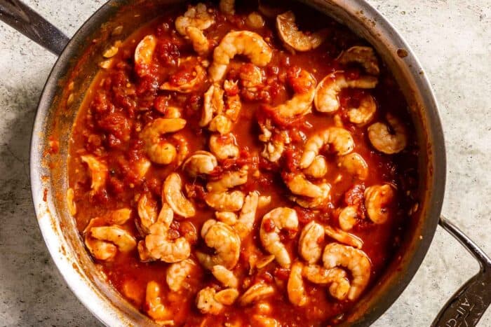 shrimp cooking in a spicy tomato sauce in a sauté pan