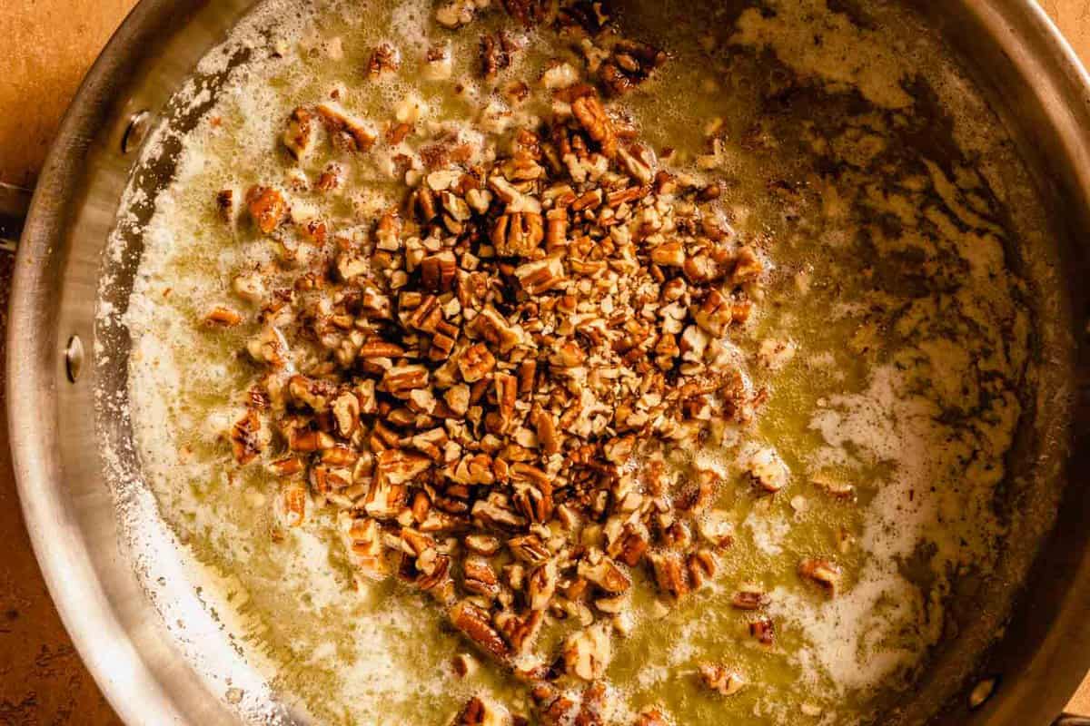 pecans in melted butter in a skillet