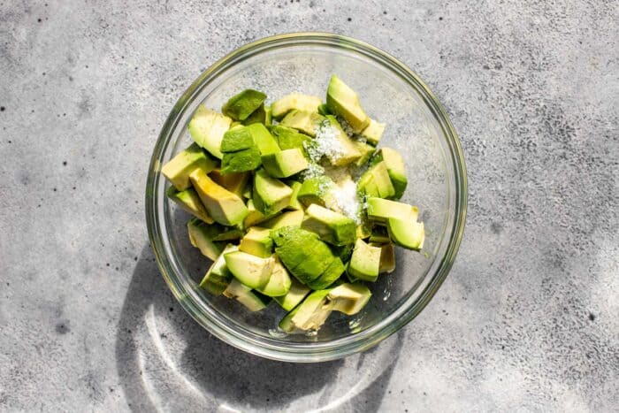 diced avocado, salt and lime juice in a small glass bowl