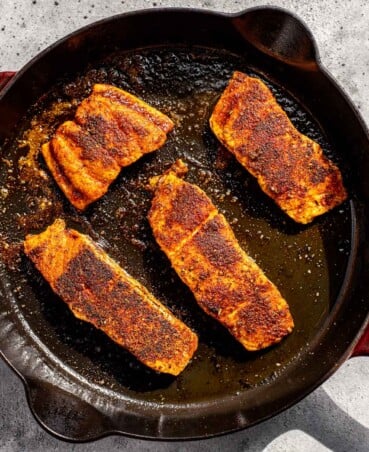 blackened salmon in a cast-iron skillet