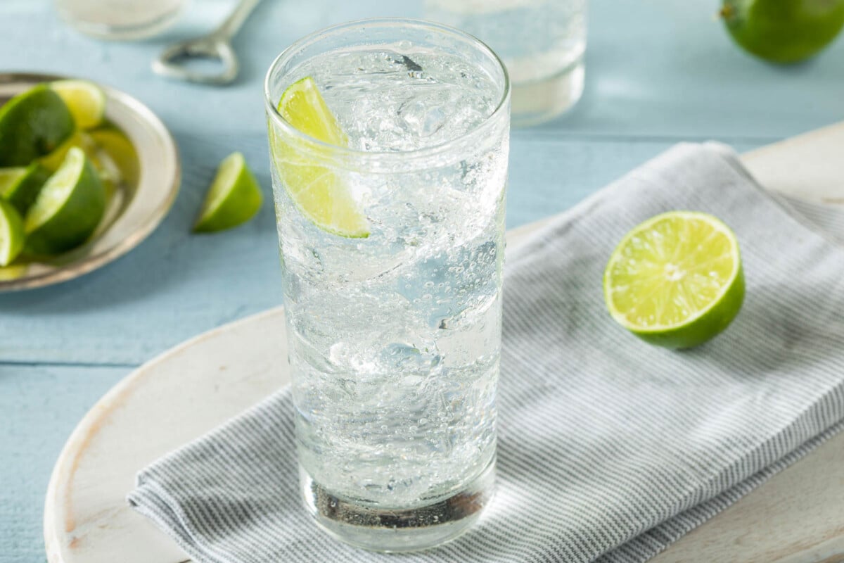club soda and lime wedges in a tall glass