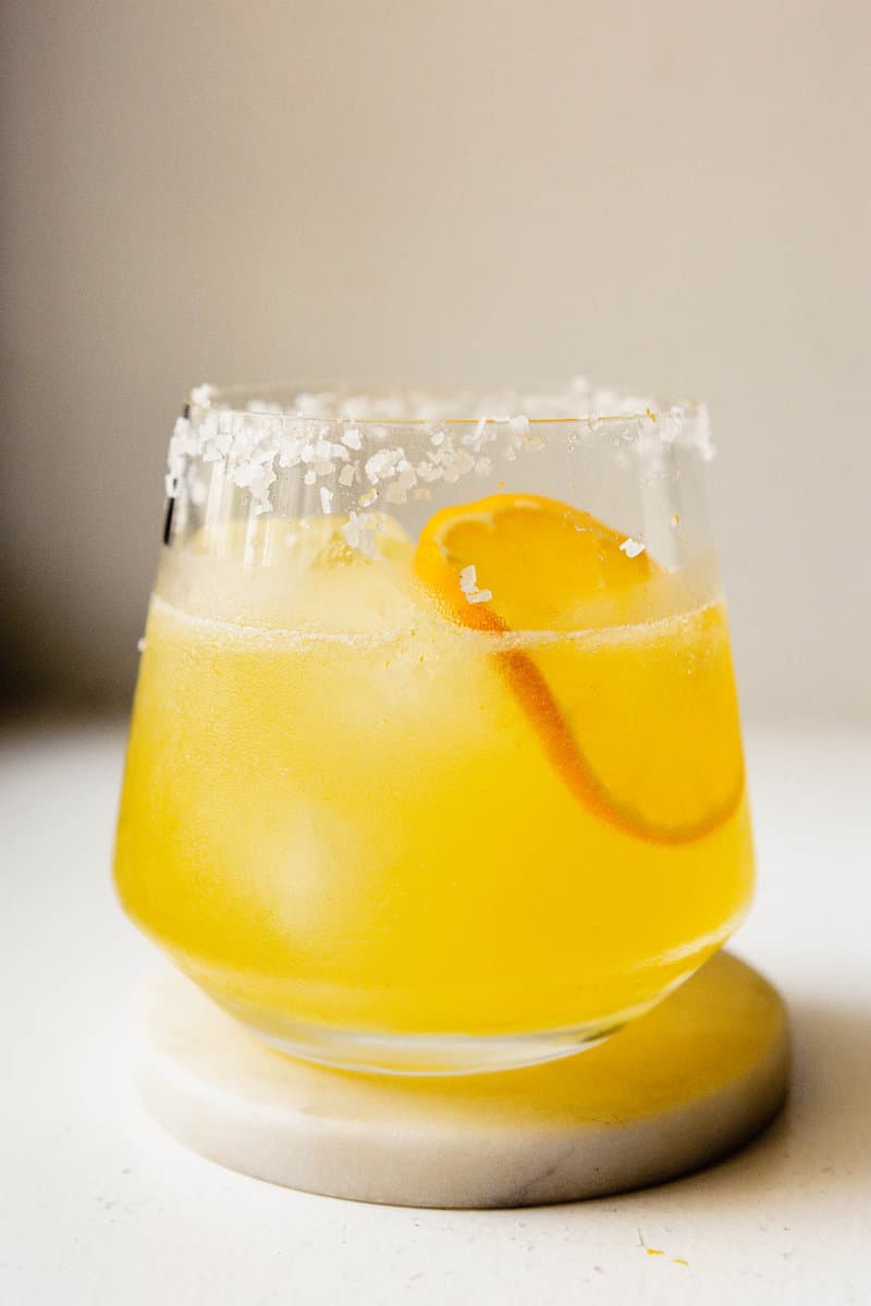 lemon margarita in a rocks glass set on a white counter