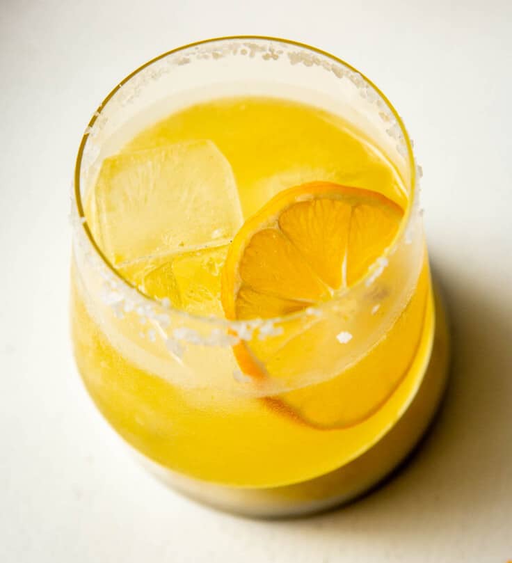 lemon margarita in a rocks glass on a white background