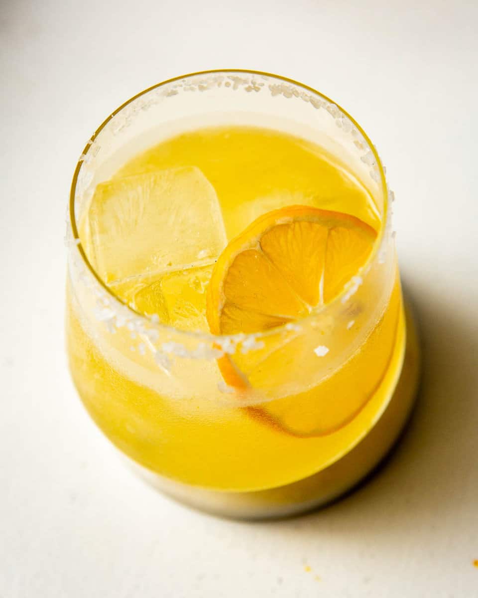 lemon margarita in a rocks glass on a white background
