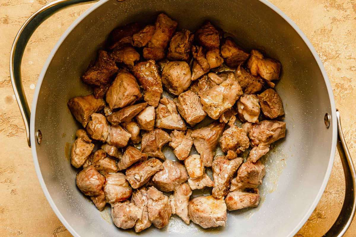 browned chunks of pork in a pot