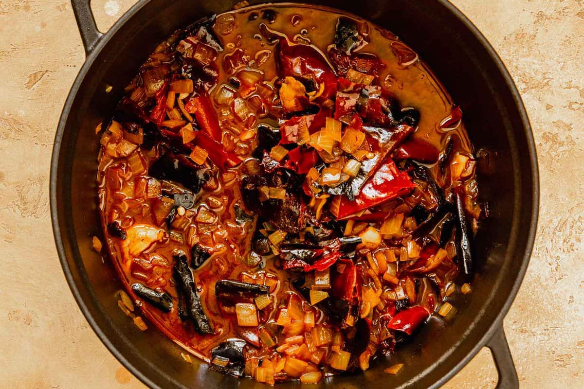 dried chiles, onion and garlic simmering in a large pot
