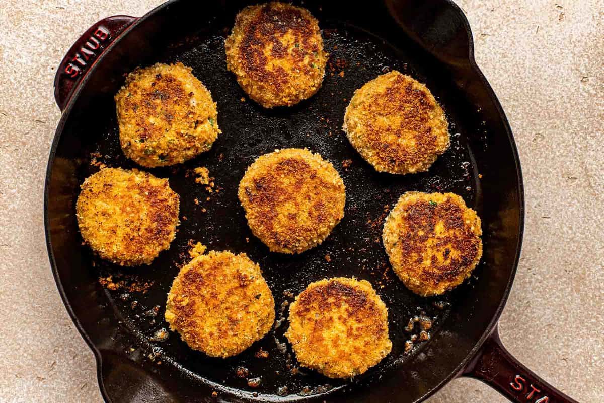 salmon croquettes in a cast-iron skillet