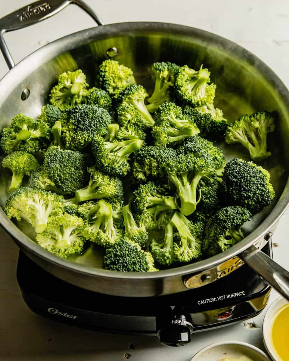 raw broccoli florets in a saute pan
