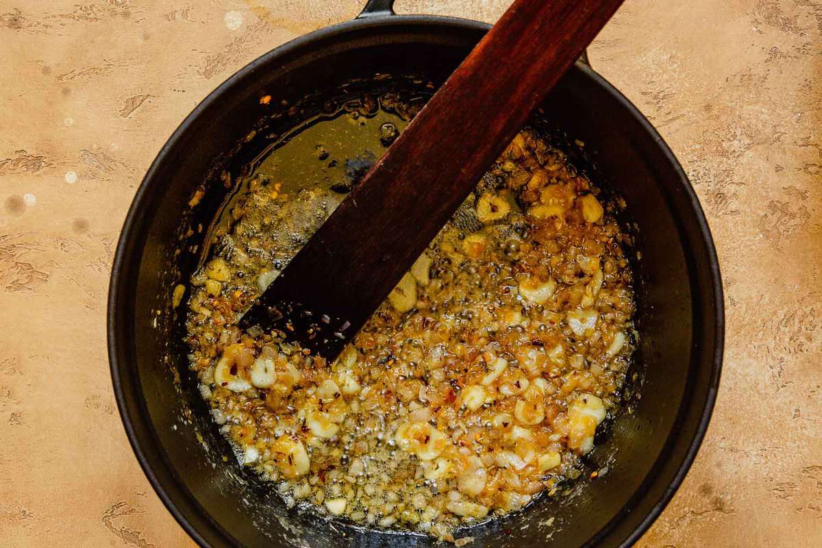 sliced garlic, shallots and spices cooking in butter in a large pot
