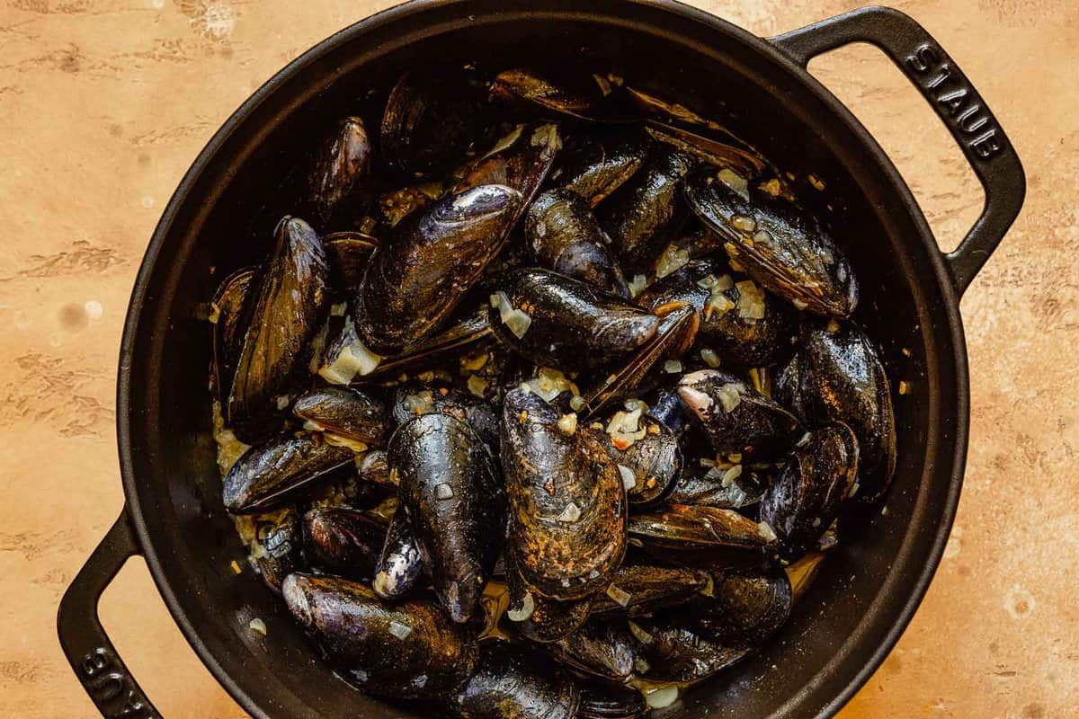 uncooked mussels in a large pot