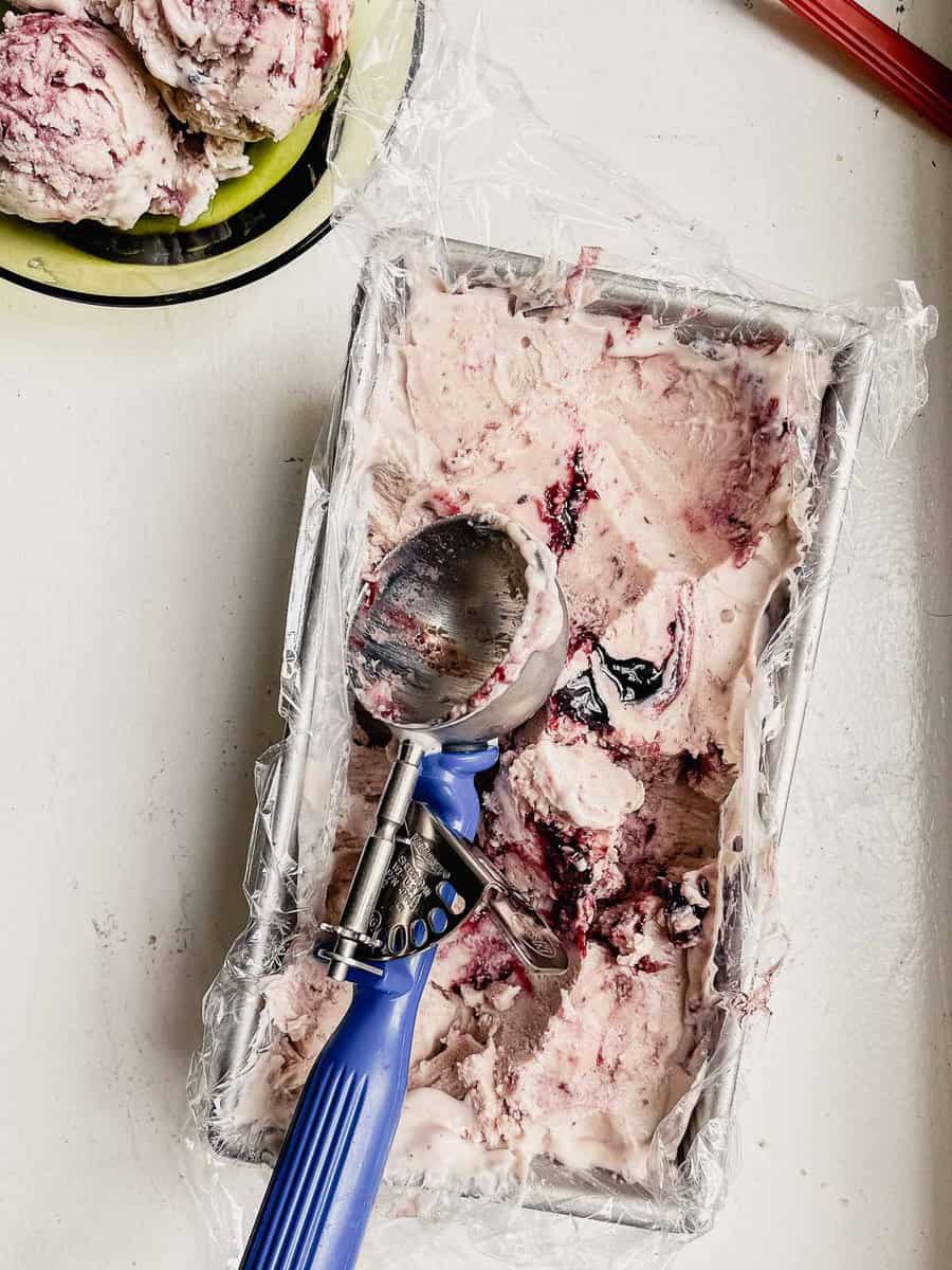 ice cream in a loaf pan with a ice cream scoop