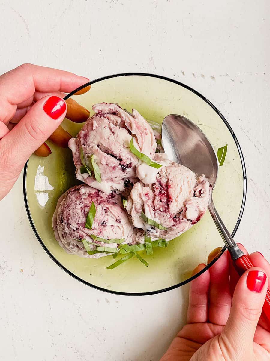 ice cream in a green glass bowl with a spoon