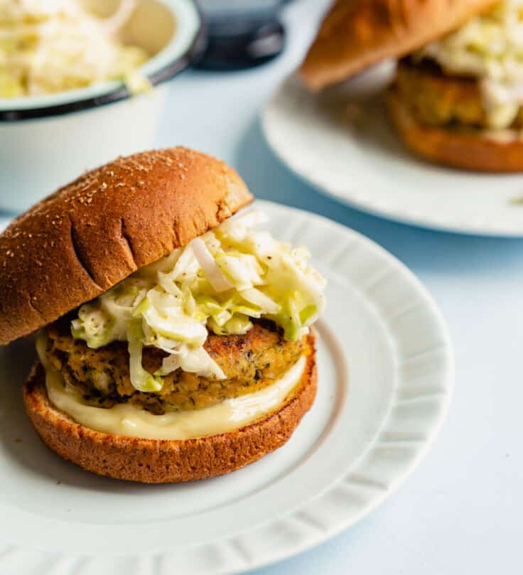 Salmon burger made with canned salmon on a whole wheat bun with slaw and mayo