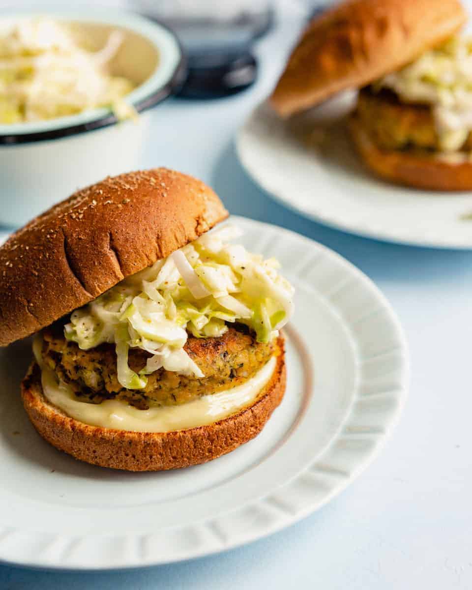 Salmon burger made with canned salmon on a whole wheat bun with slaw and mayo