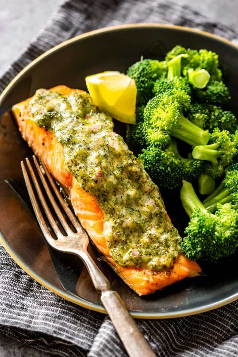 herby mayo salmon on a plate with a fork and broccoli