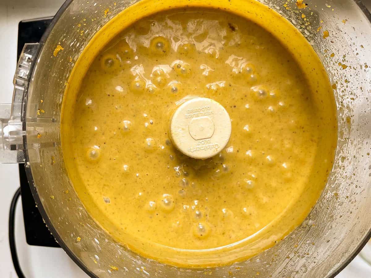 thin yellow pistachio cake batter in a food processor