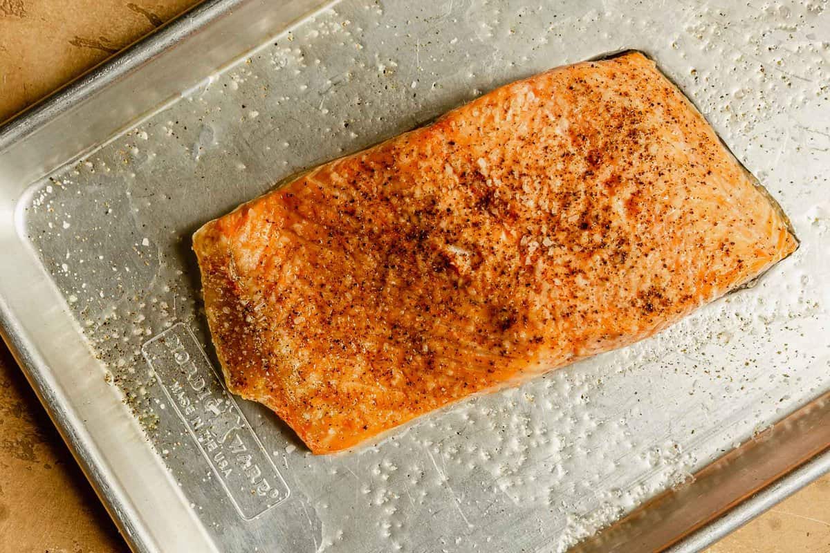 broiled fillet of salmon on a baking sheet