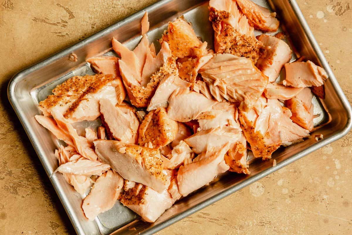 large flakes of salmon on a baking sheet