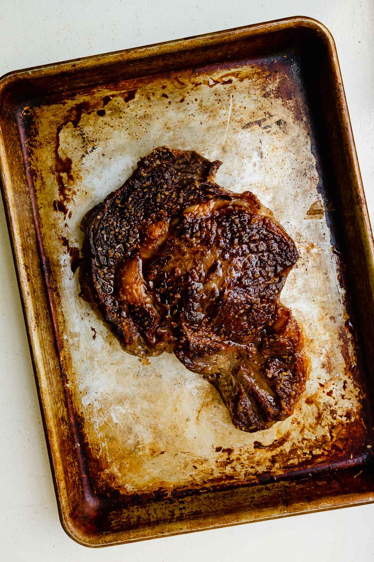cooked steak on a baking sheet
