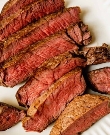 sliced steak on a white plate