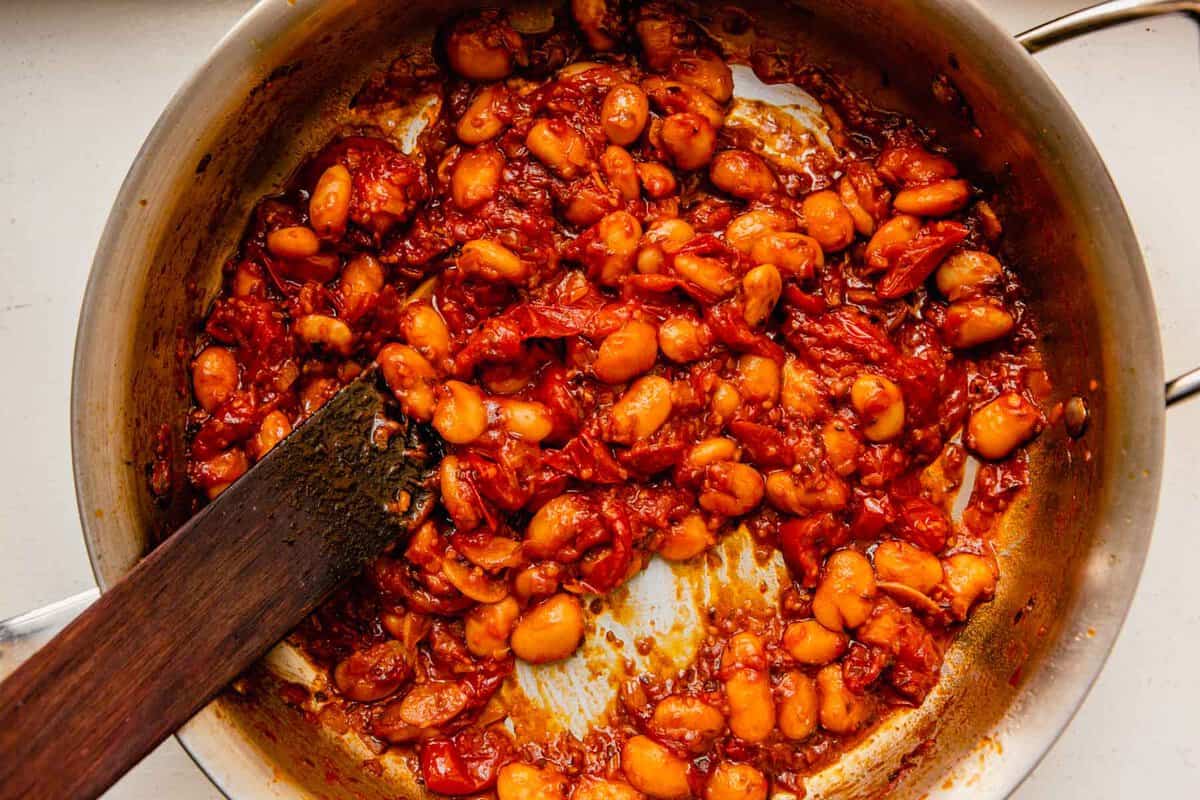 butter beans in a tomato sauce in a saute pan