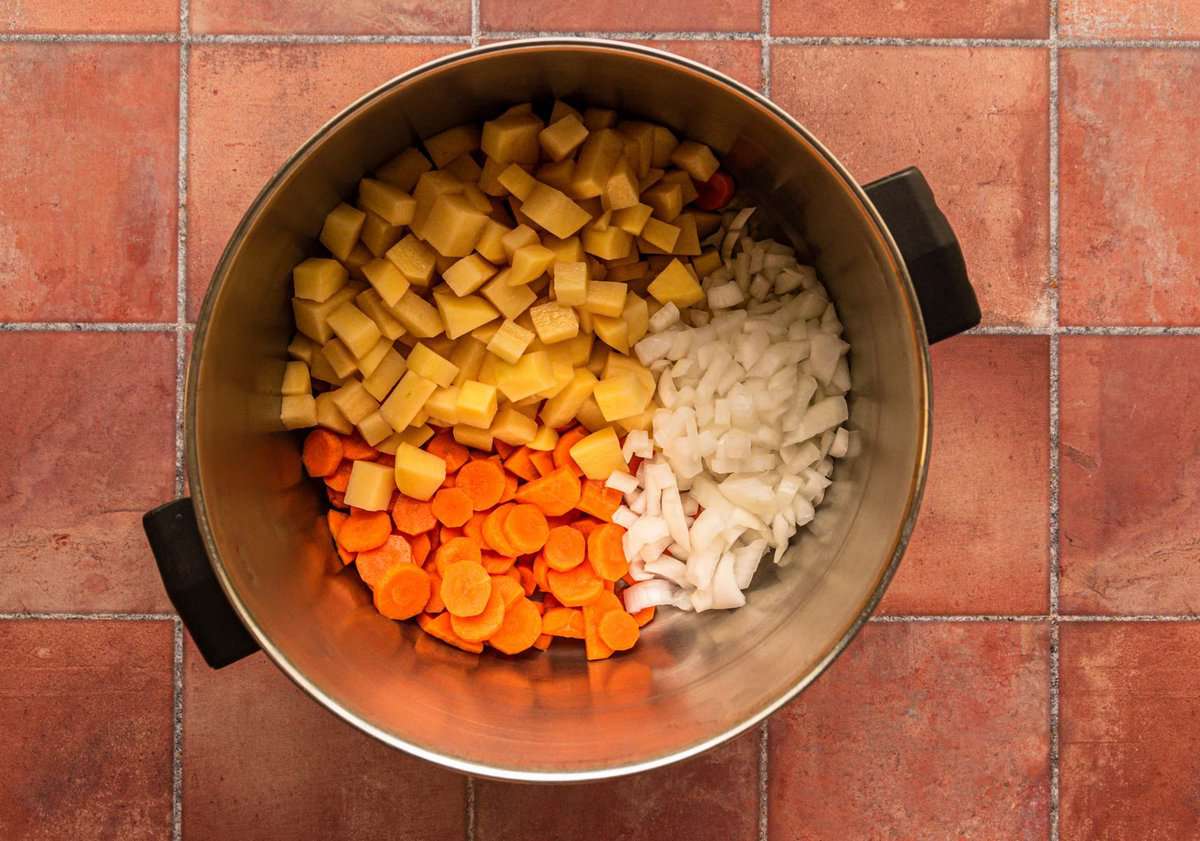 diced carrots, onions and potatoes in a large pot