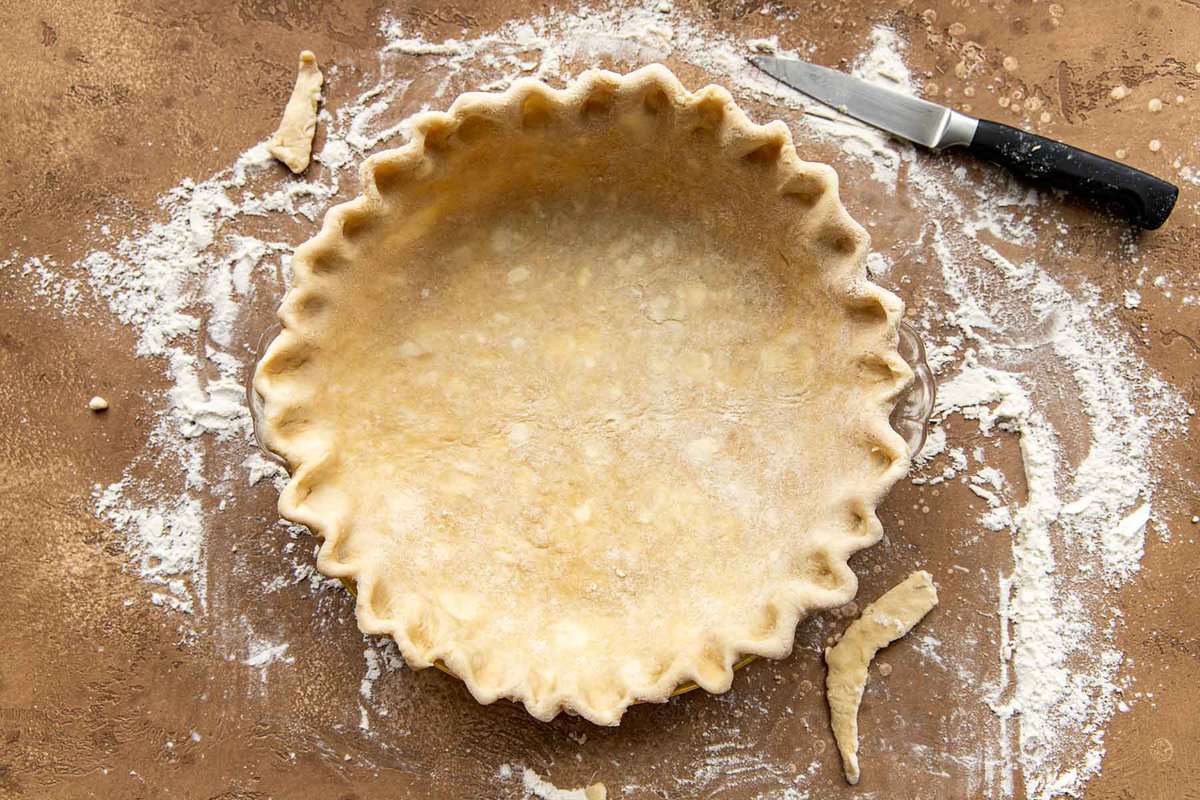 Unbaked pie crust lining a pie plate