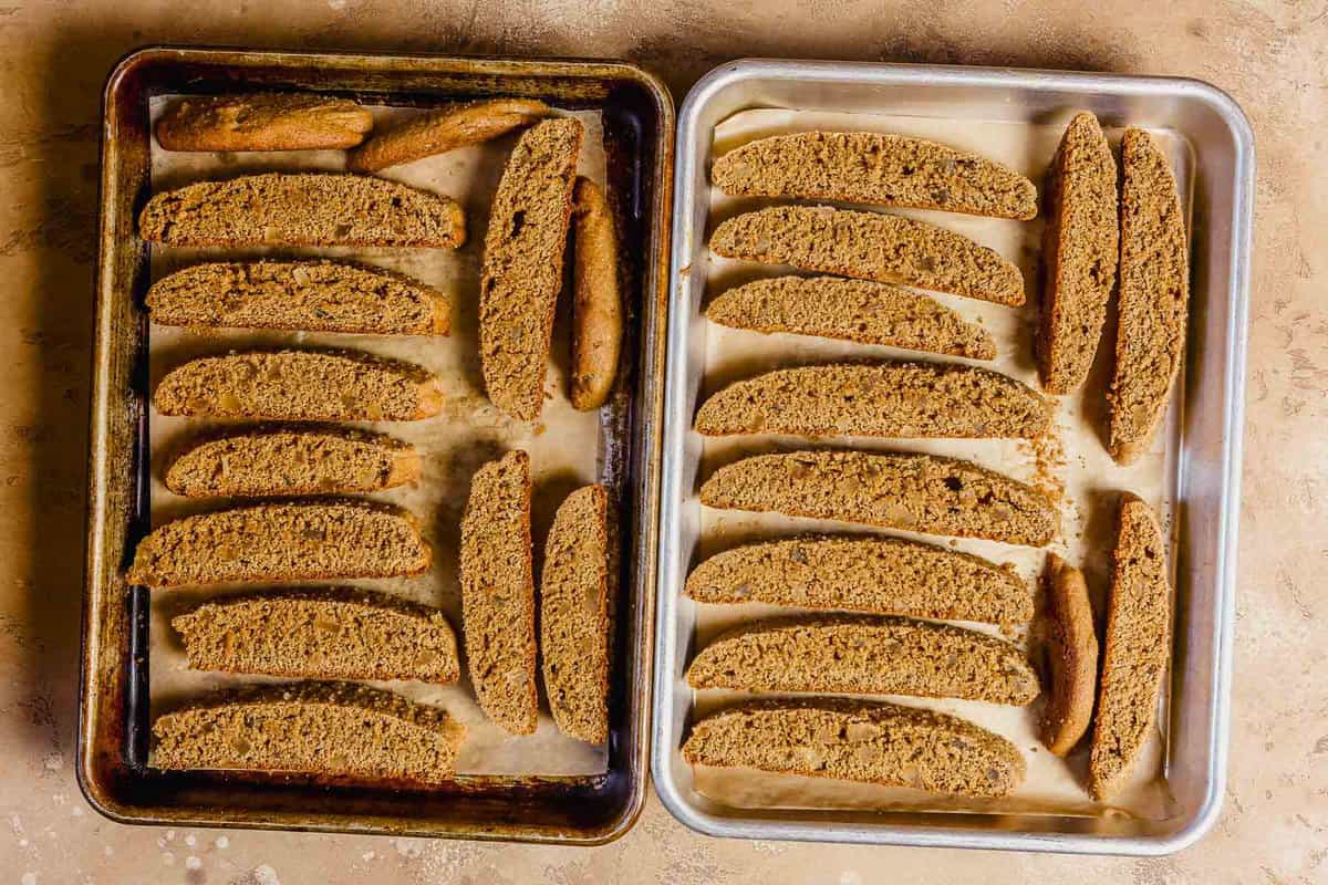 Partially baked gingerbread biscotti on baking sheets.