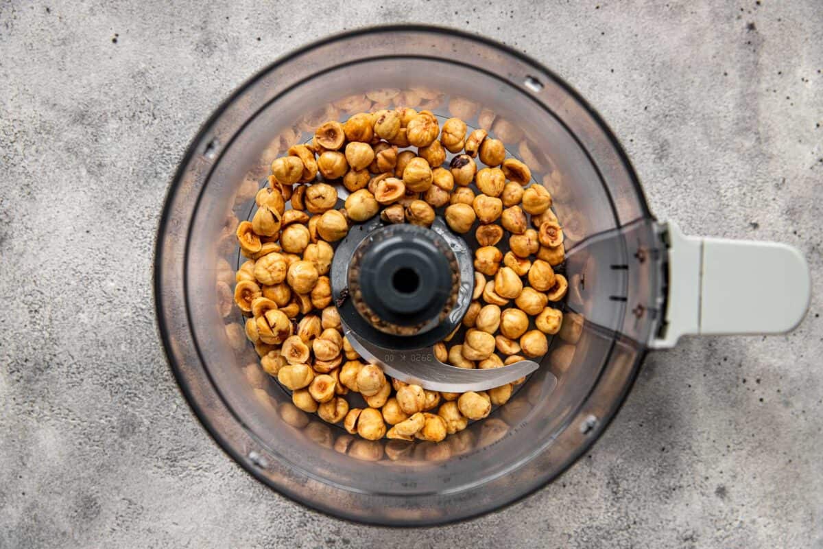 Toasted hazelnuts in a mini food processor.