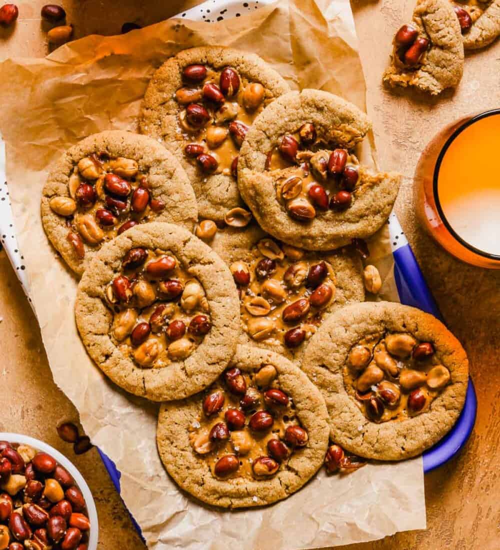 This photo shows 7 Nancy Silverton Peanut Butter Cookies on a piece of parchment paper. 