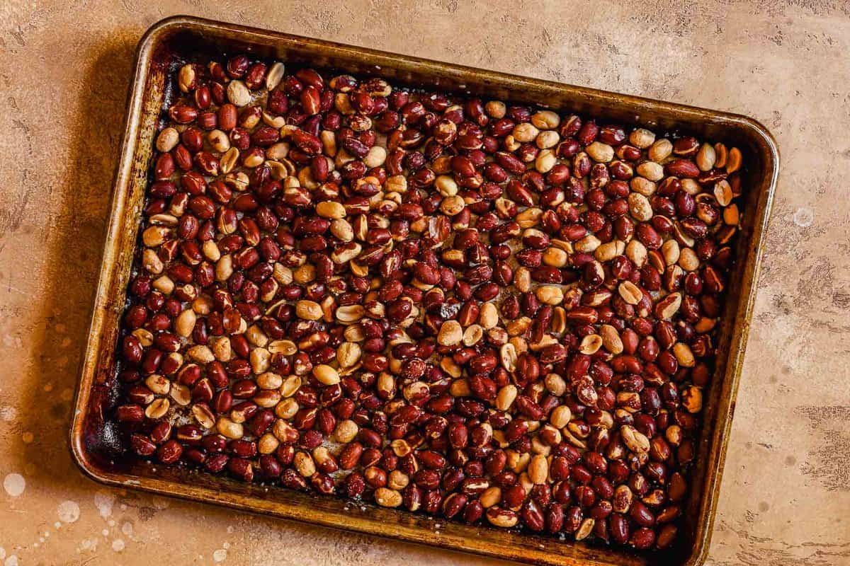 Toasted spanish peanuts on a baking sheet.
