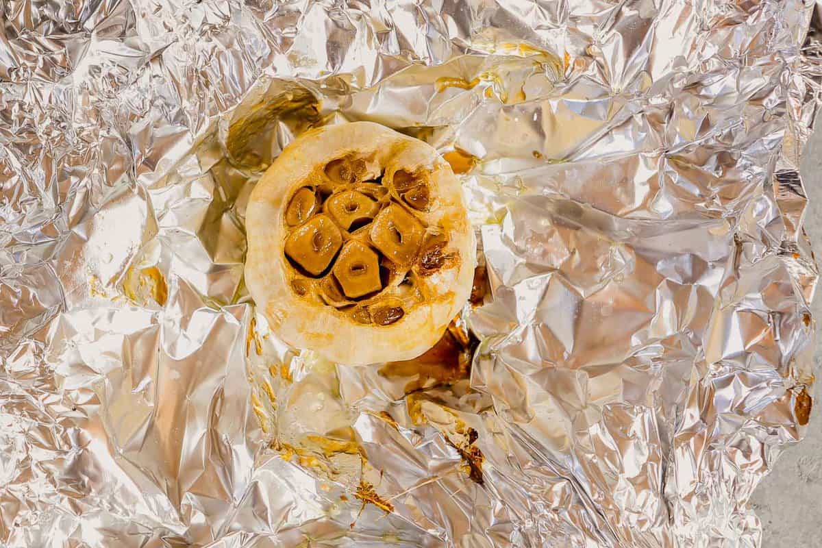 a roasted bulb of garlic in a piece of foil