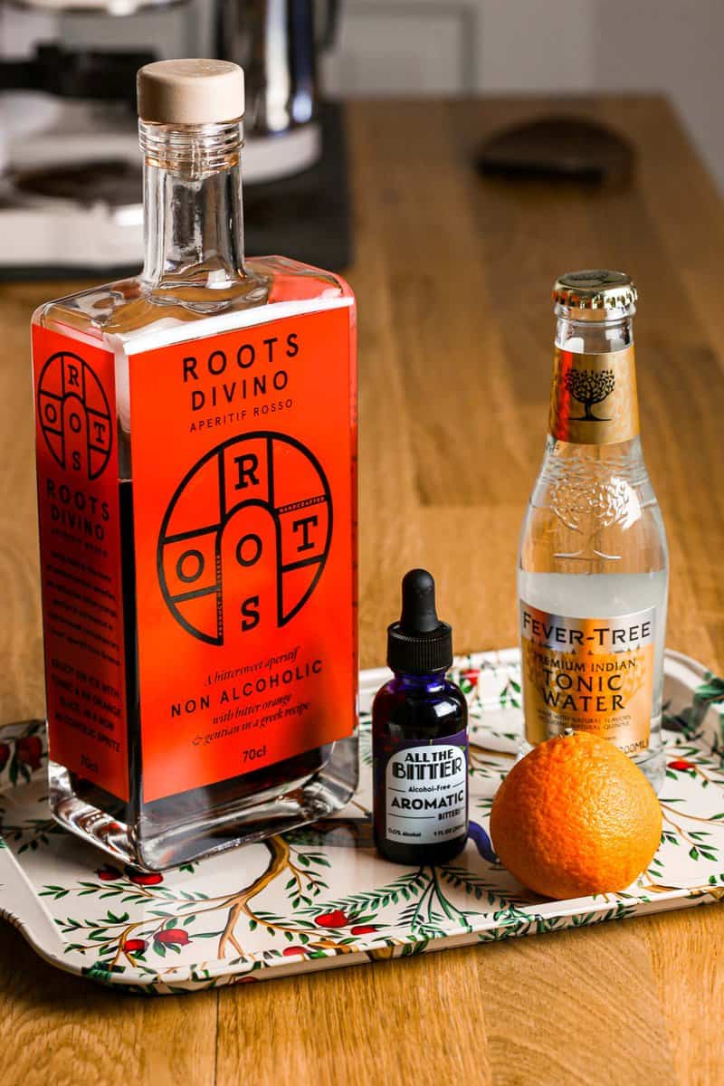 Roots Divino Rosso set on a platter with an orange, tonic water and bitters.
